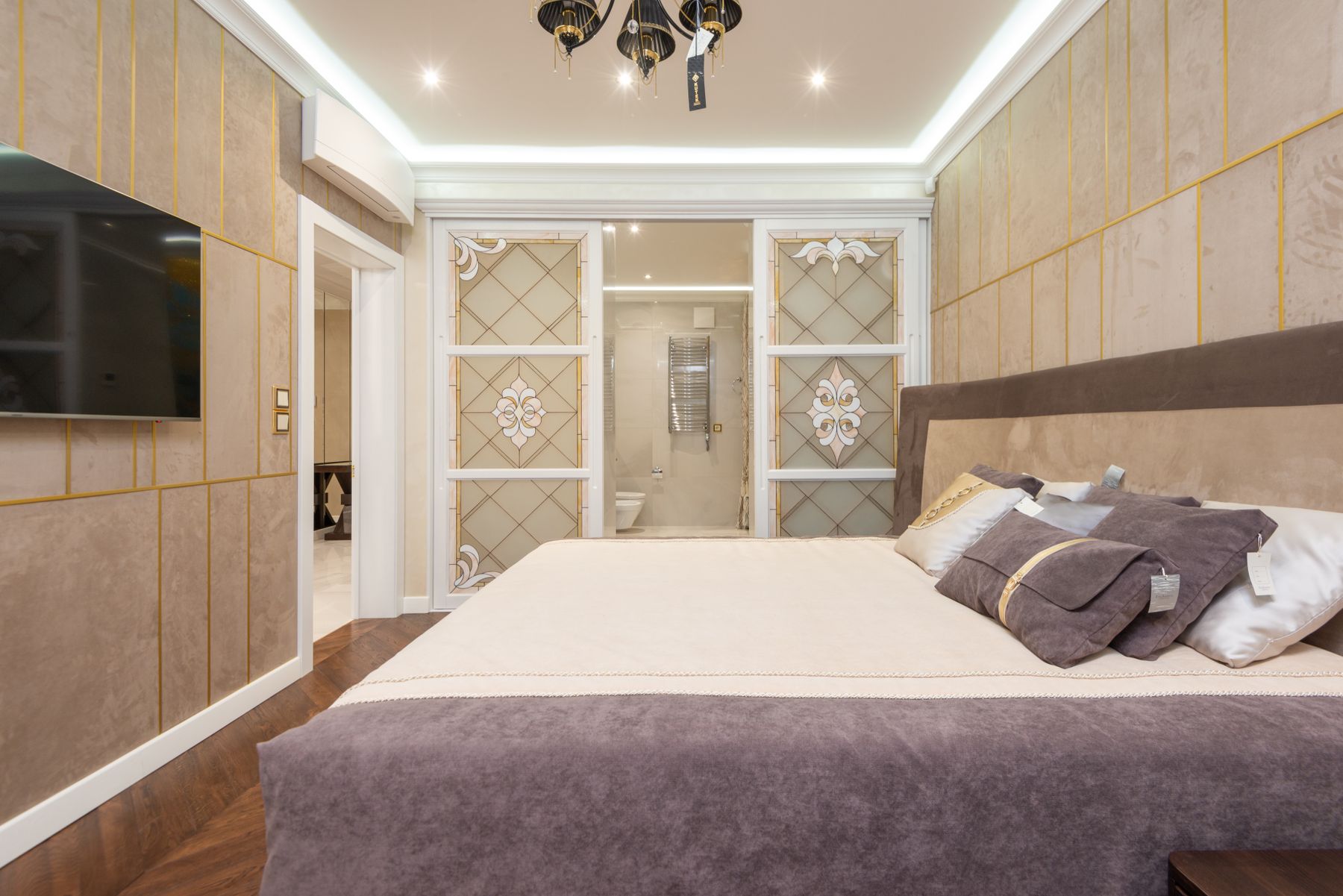 Luxury bedroom suite with a discreet wall mounted split air conditioning unit